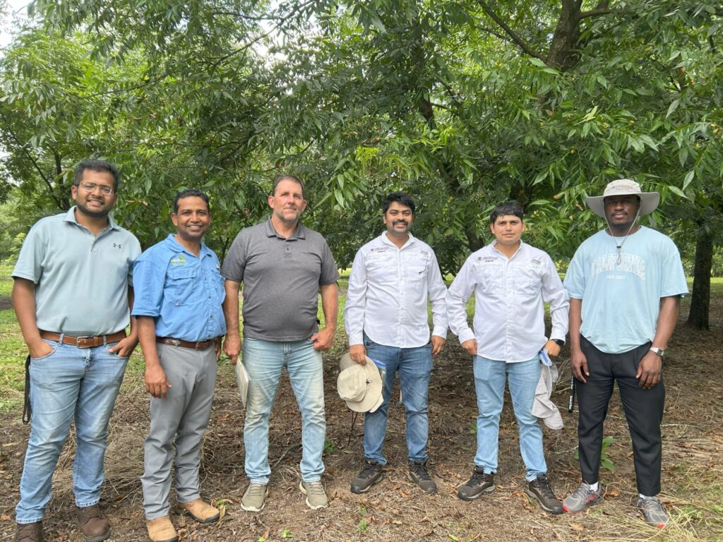 Joshua with a pecan grower, ANR agent and Dr. Barman's lab crew