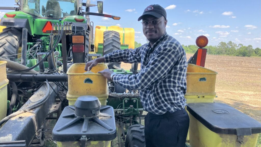 Joshua working a cotton planter
