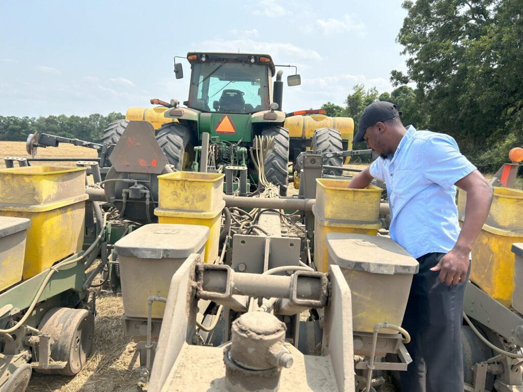 Joshua working a cotton planter